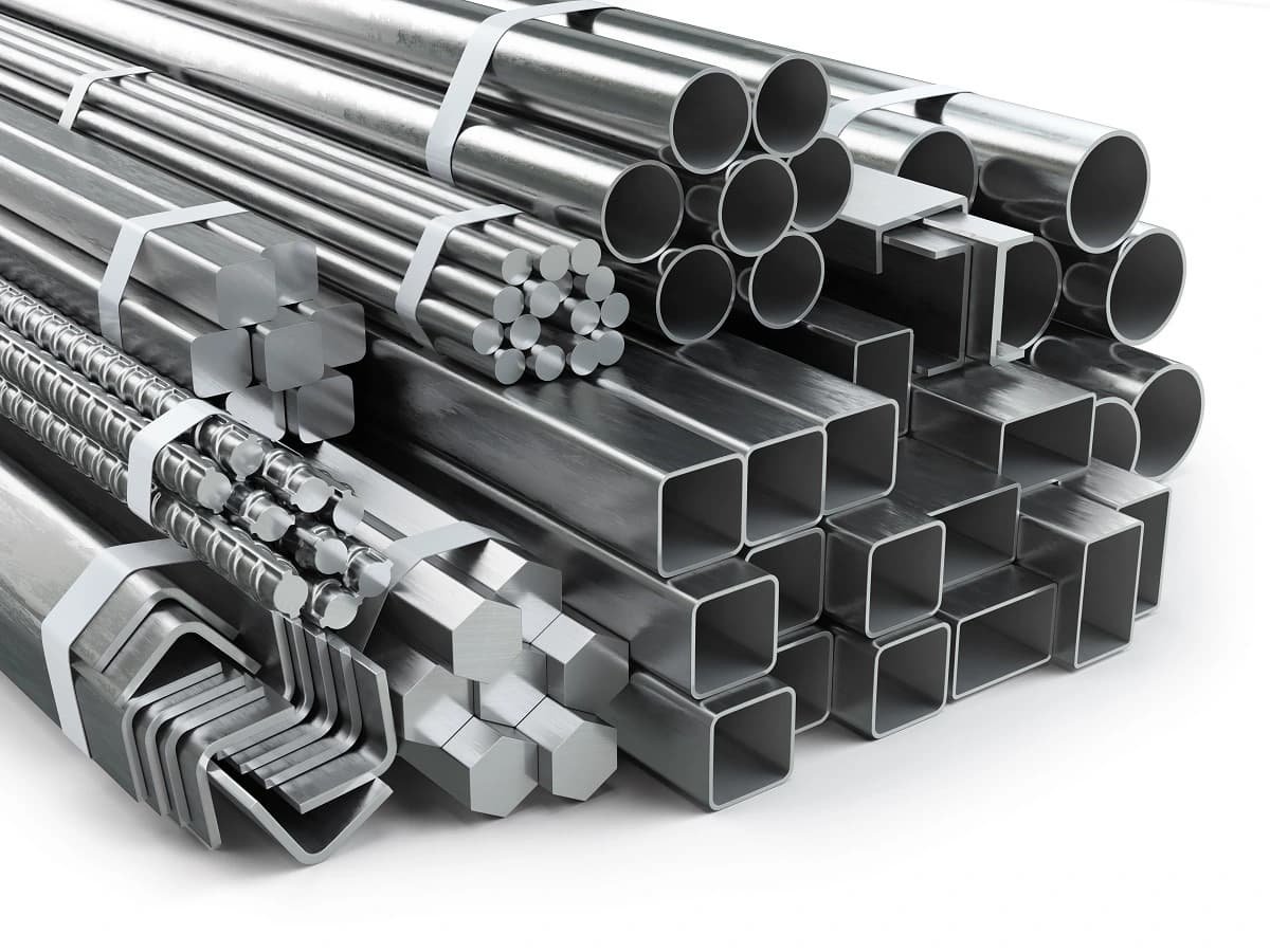 Stack of steel construction profiles: round and square hollow sections, angles, channels, round and hexagonal bars and rebar, strapped in bundles.