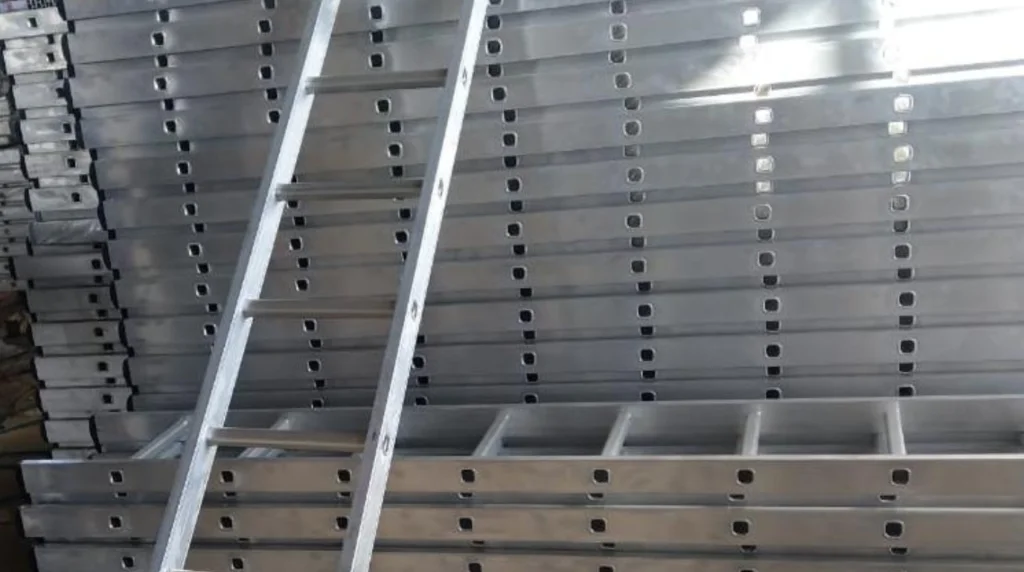 Aluminium ladder standing in front of stacked aluminium formwork panels and profiles in the GH Scaffolds warehouse.